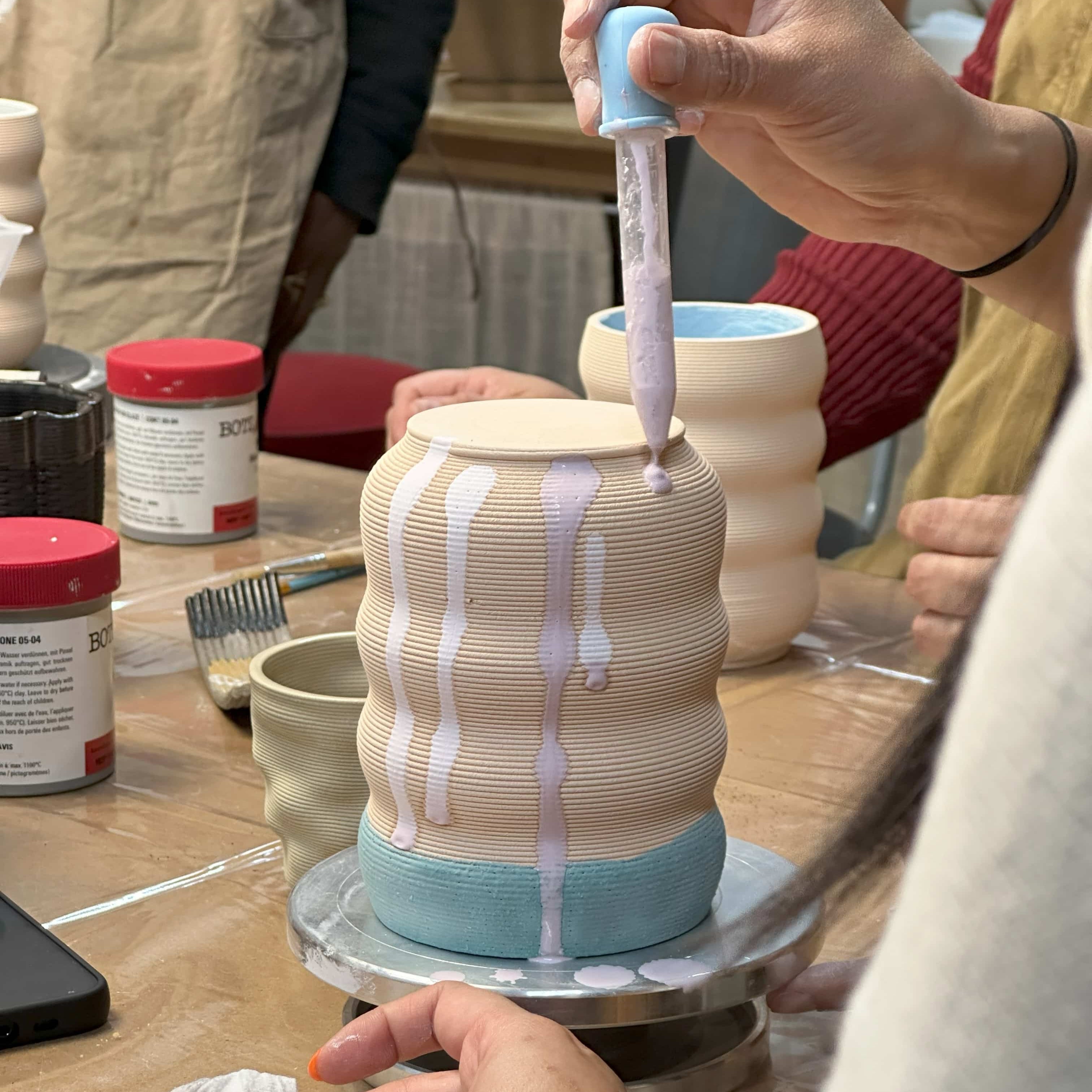 Participants painting 3D printed ceramics during a sound bath workshop in Berlin