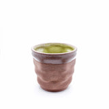 3D printed ceramic coffee mug with ripple texture and green glazed interior from the Migration of Matter collection